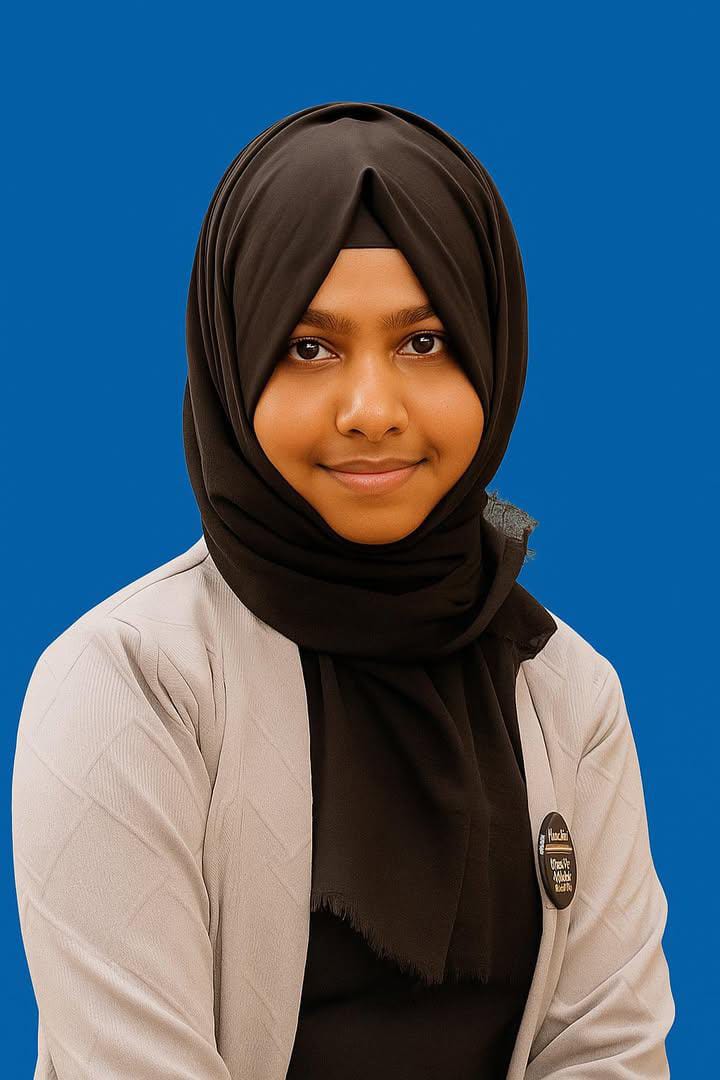 Professional headshot of Thahira Shareen, a young Indian woman with a confident smile, wearing business attire, set against a neutral background